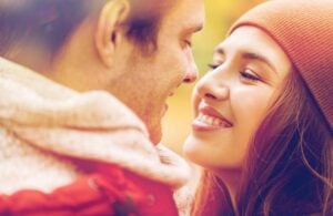 A young couple kissing outdoors