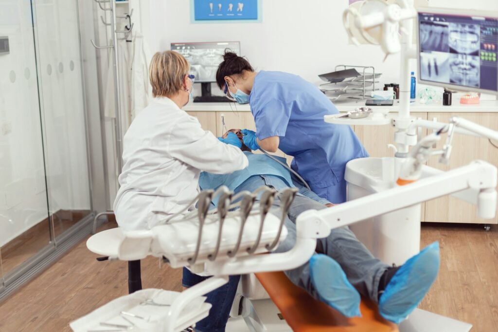 Dental hygienist cleaning a patient's teeth at Icon Dental Center in Everett