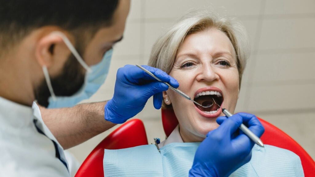 Orthodontist repairing a broken bracket during an appointment