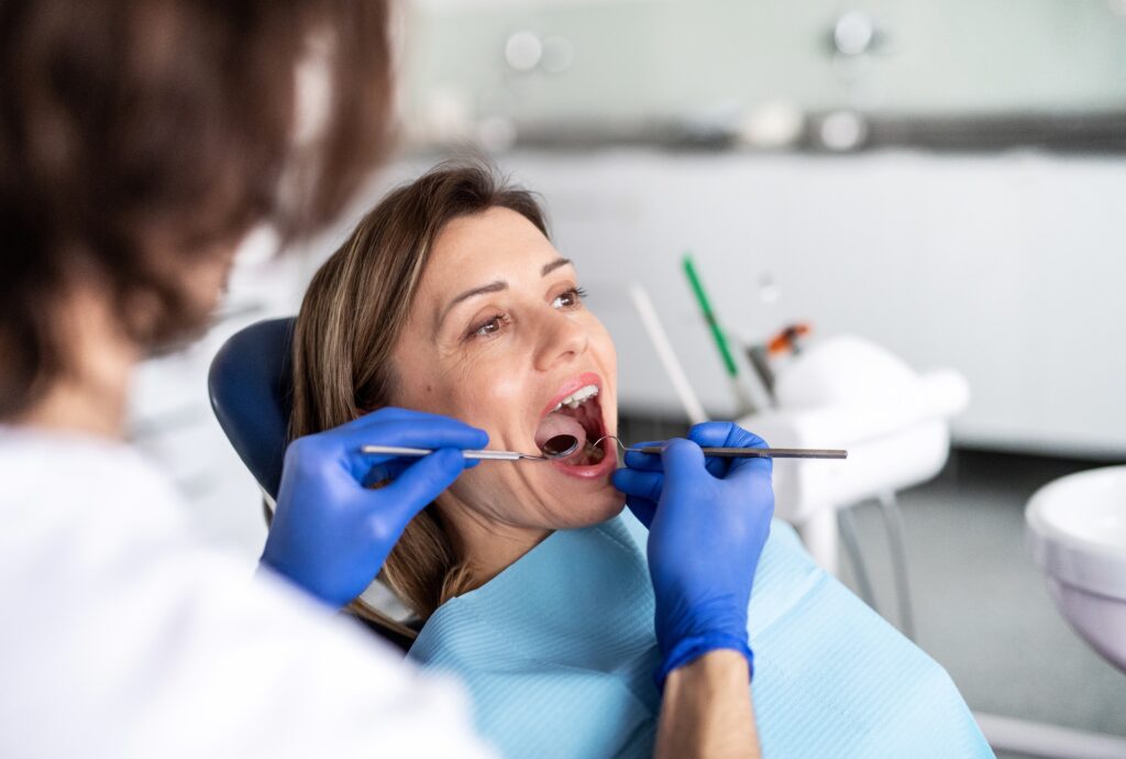 Dentist examining a patient's tooth before an extraction