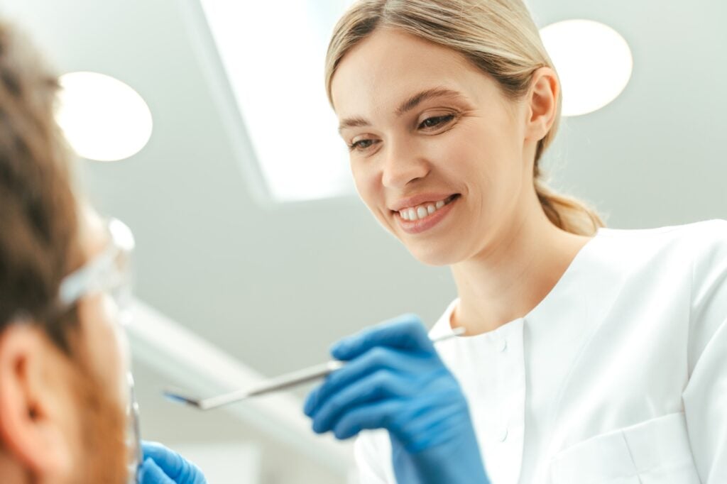 Dentist checking a patient's teeth during a routine exam