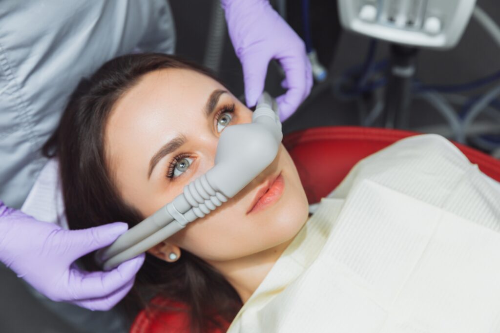 Dentist fitting a nitrous oxide mask for a comfortable procedure